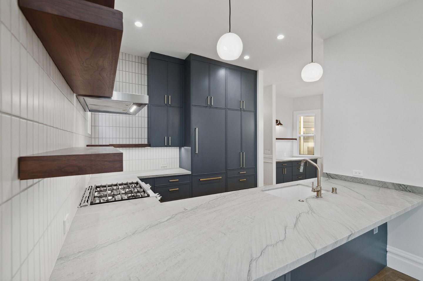 Victorian kitchen — stone island and custom range hood