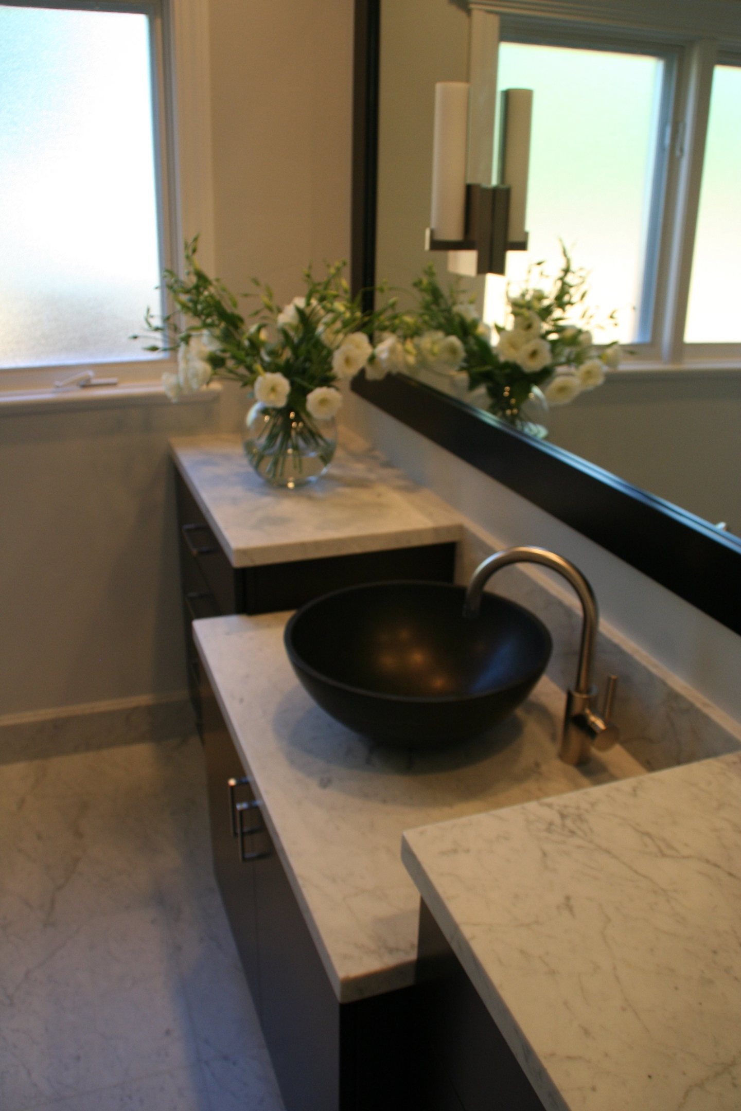 Ondyak — master bath — white stone vanity and black vessel sink — view 3 in the bathroom