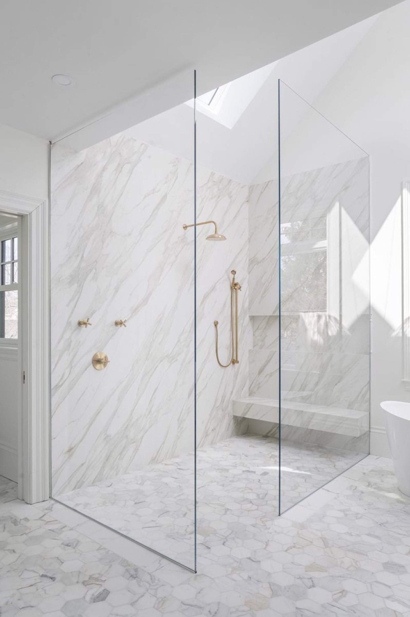 White marble bathroom with brass fixtures