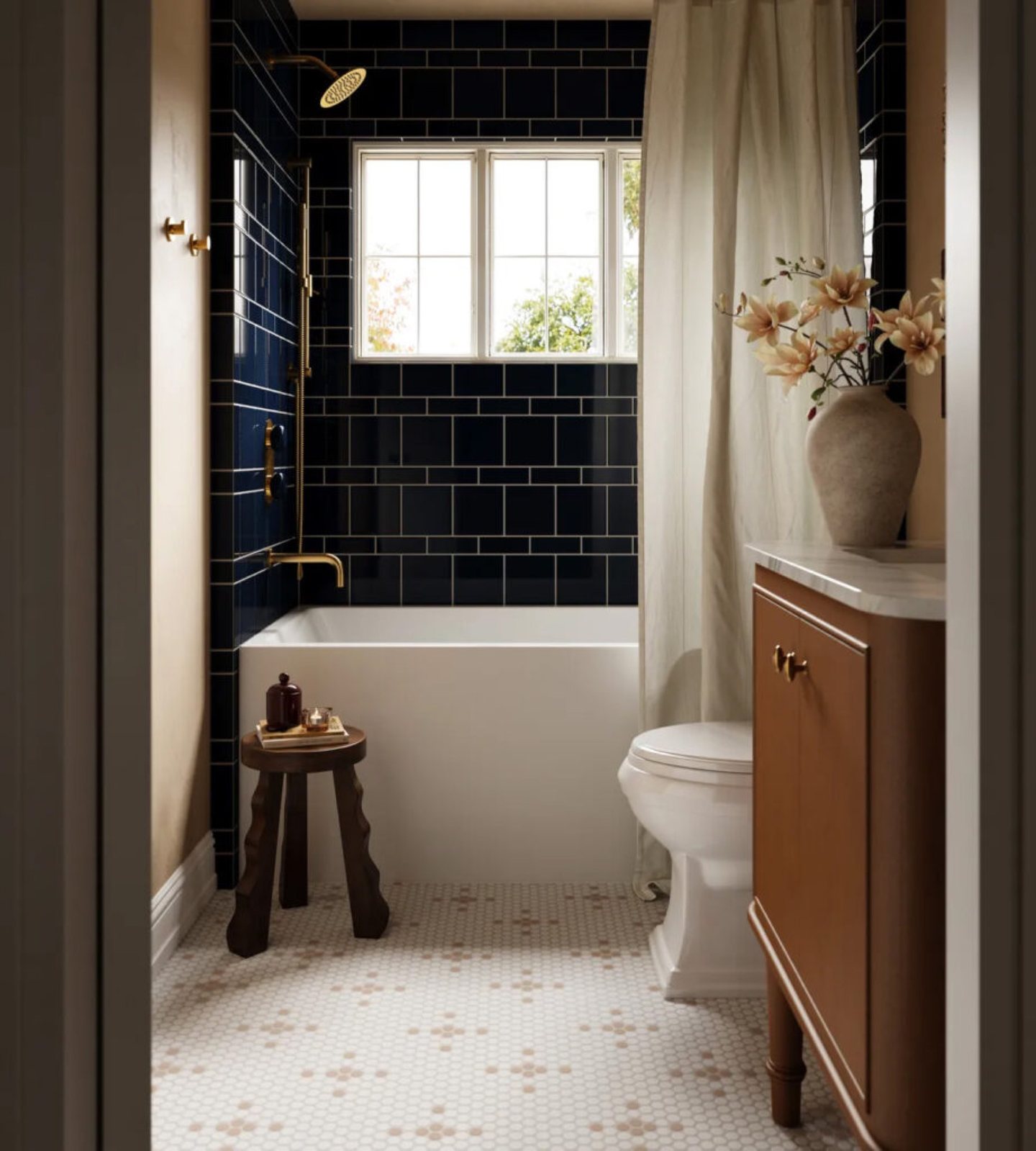 Dark blue tile bathroom with a wood vanity and patterned mosaic floor