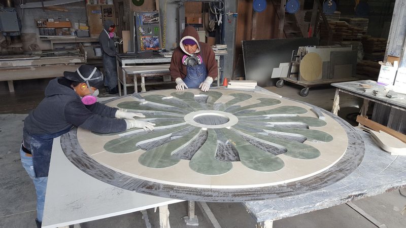 Hand-finishing a custom stone floor medallion