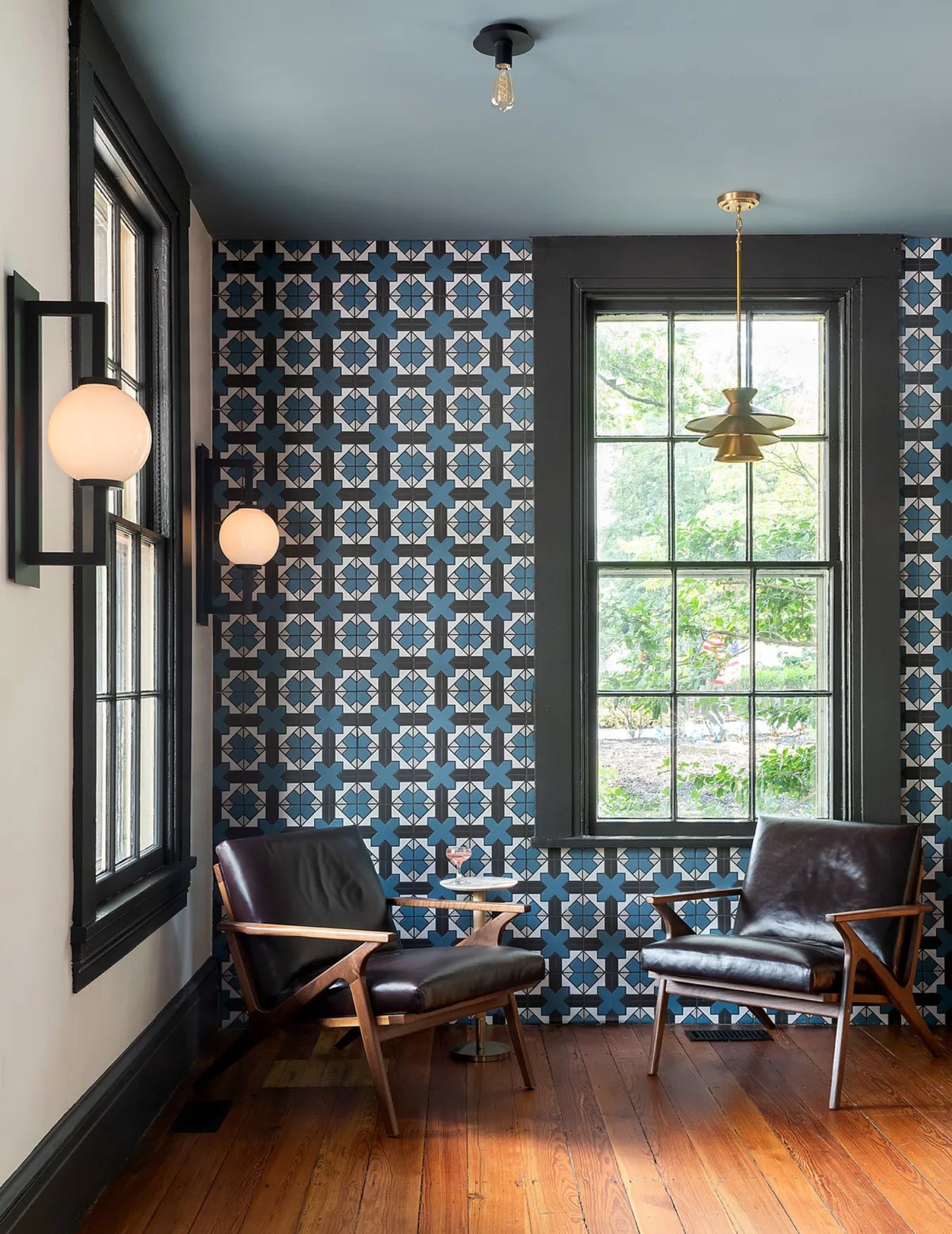 Blue patterned tile feature wall with a sculptural white pendant light